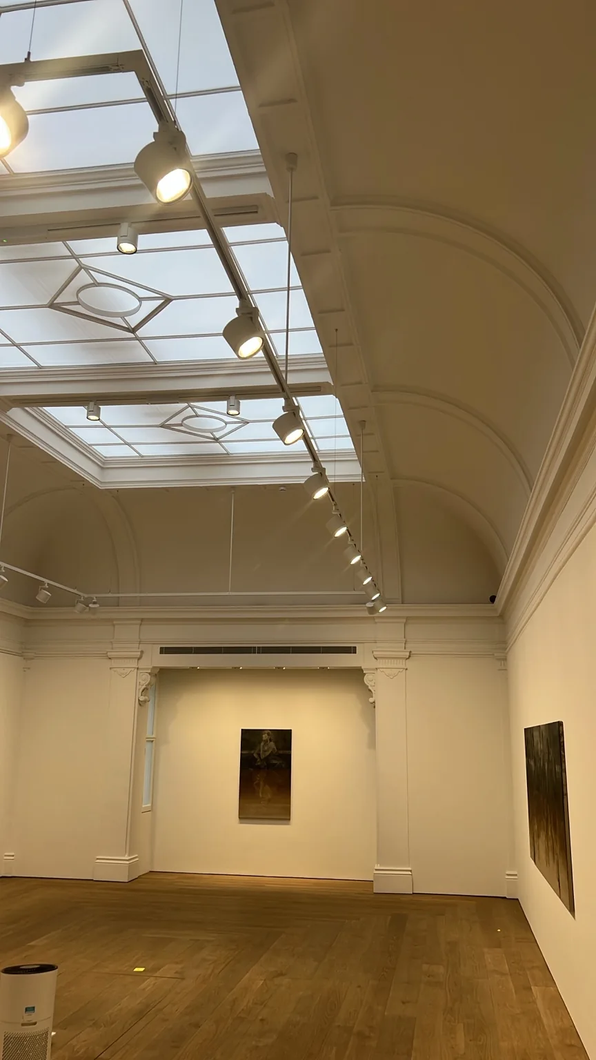 Gallery track lighting beneath a glazed ceiling at our Savile Row project